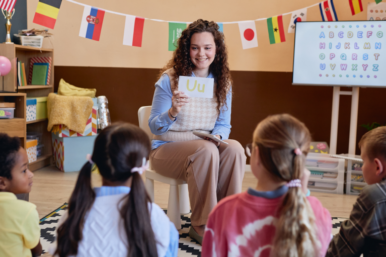 A teacher conducting Montessori learning activities with preschool children in a Montessori classroom during a teacher training programme.